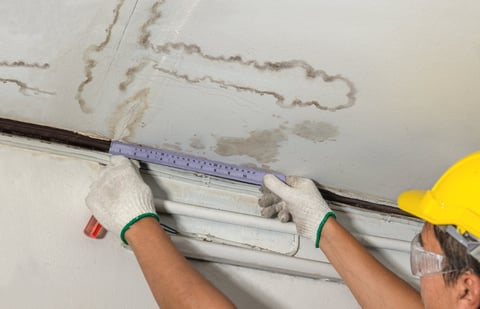 Worker fixing leaking pipe